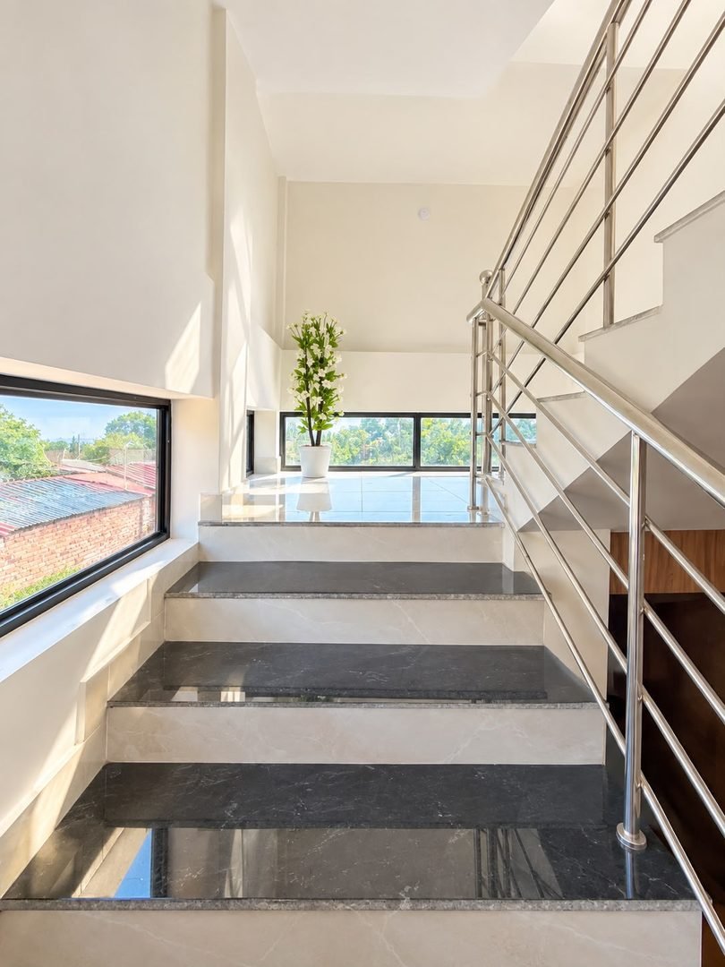 Marble Staircase with Steel Railing and Natural Light
